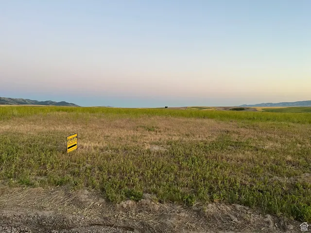Nature at dusk featuring a mountain view and a rural view