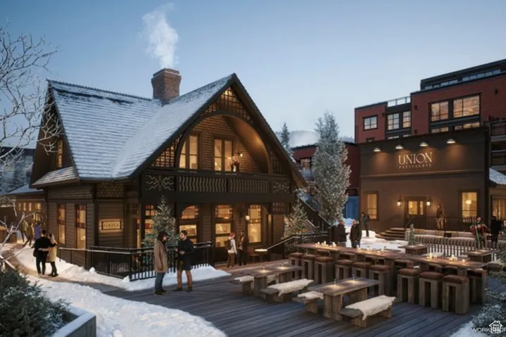 Snow covered property with a wooden deck