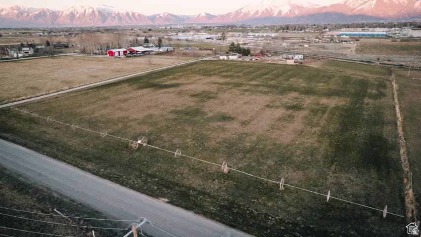 Aerial view at dusk featuring a mountain view and a rural view