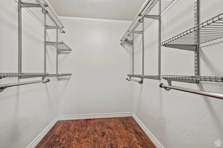 Walk in closet featuring wood finished floors