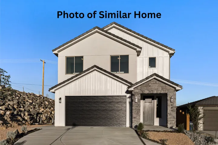 Modern farmhouse featuring driveway, a garage, and stone siding