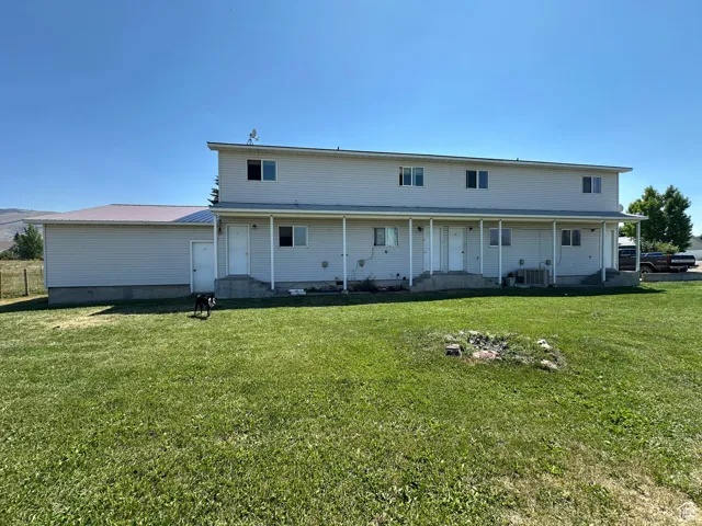 Rear view of property featuring a yard
