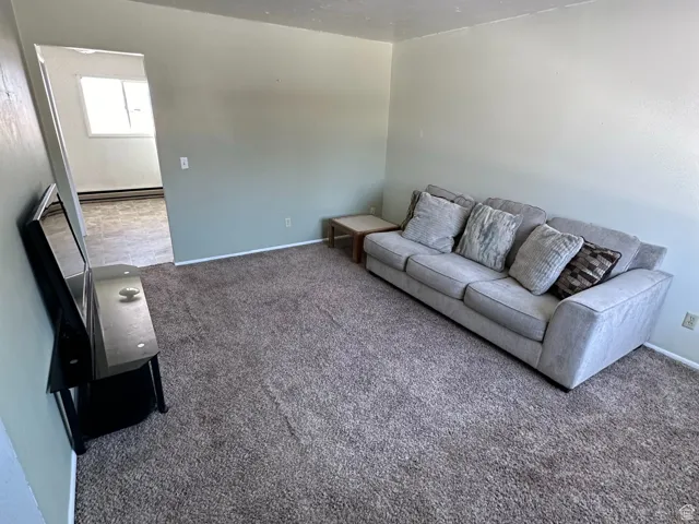 Unfurnished living room featuring carpet flooring