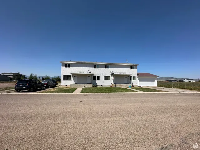 View of front of house featuring a garage, crawl space, and a front yard