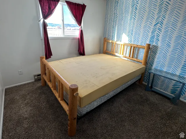 Carpeted bedroom featuring a textured ceiling
