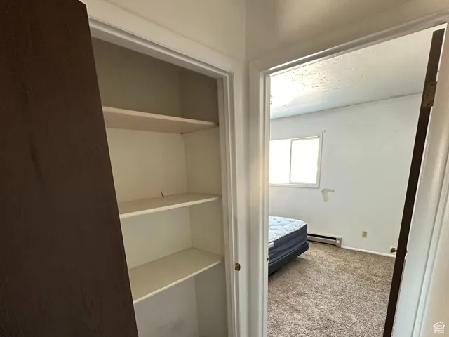 Closet featuring baseboard heating