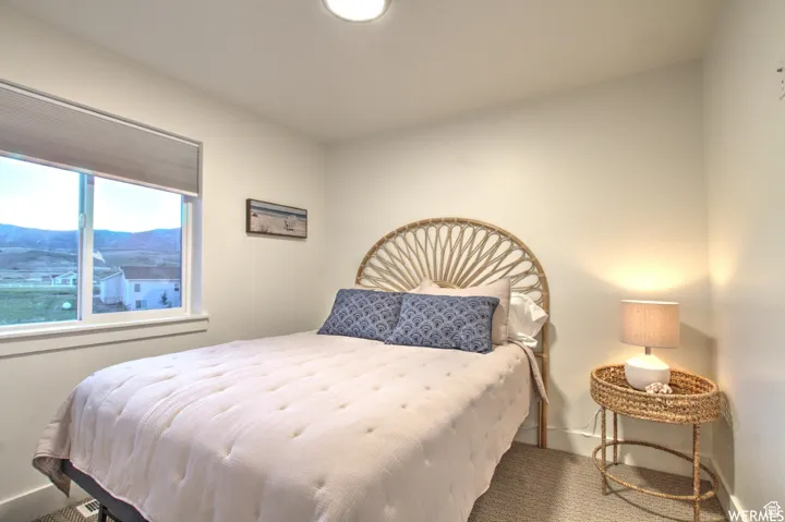 Bedroom featuring a mountain view and carpet