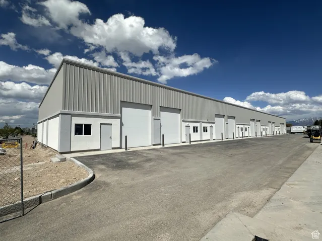 View of outbuilding featuring community garages