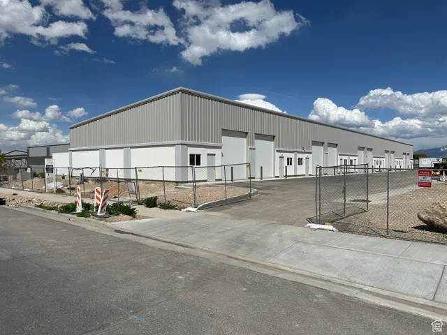 View of property with fence and a garage