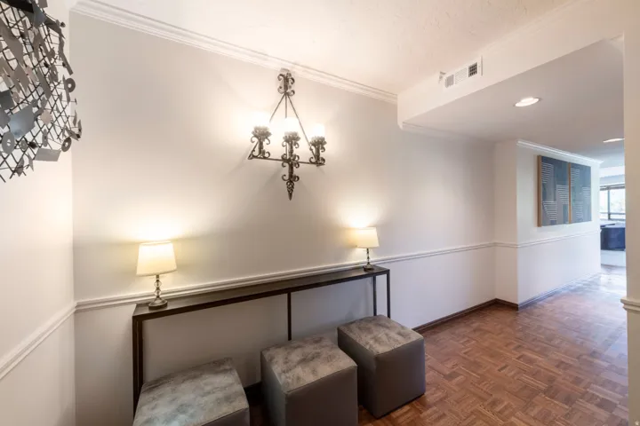 Entryway featuring parquet wood flooring, crown molding, and wainscoting