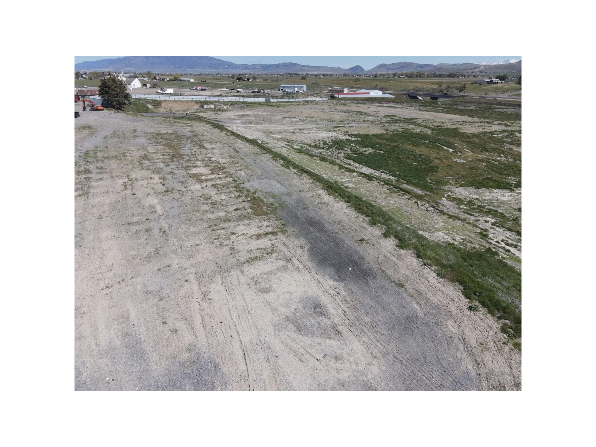 View of dirt / gravel road with a mountain view and a view of rural / pastoral area