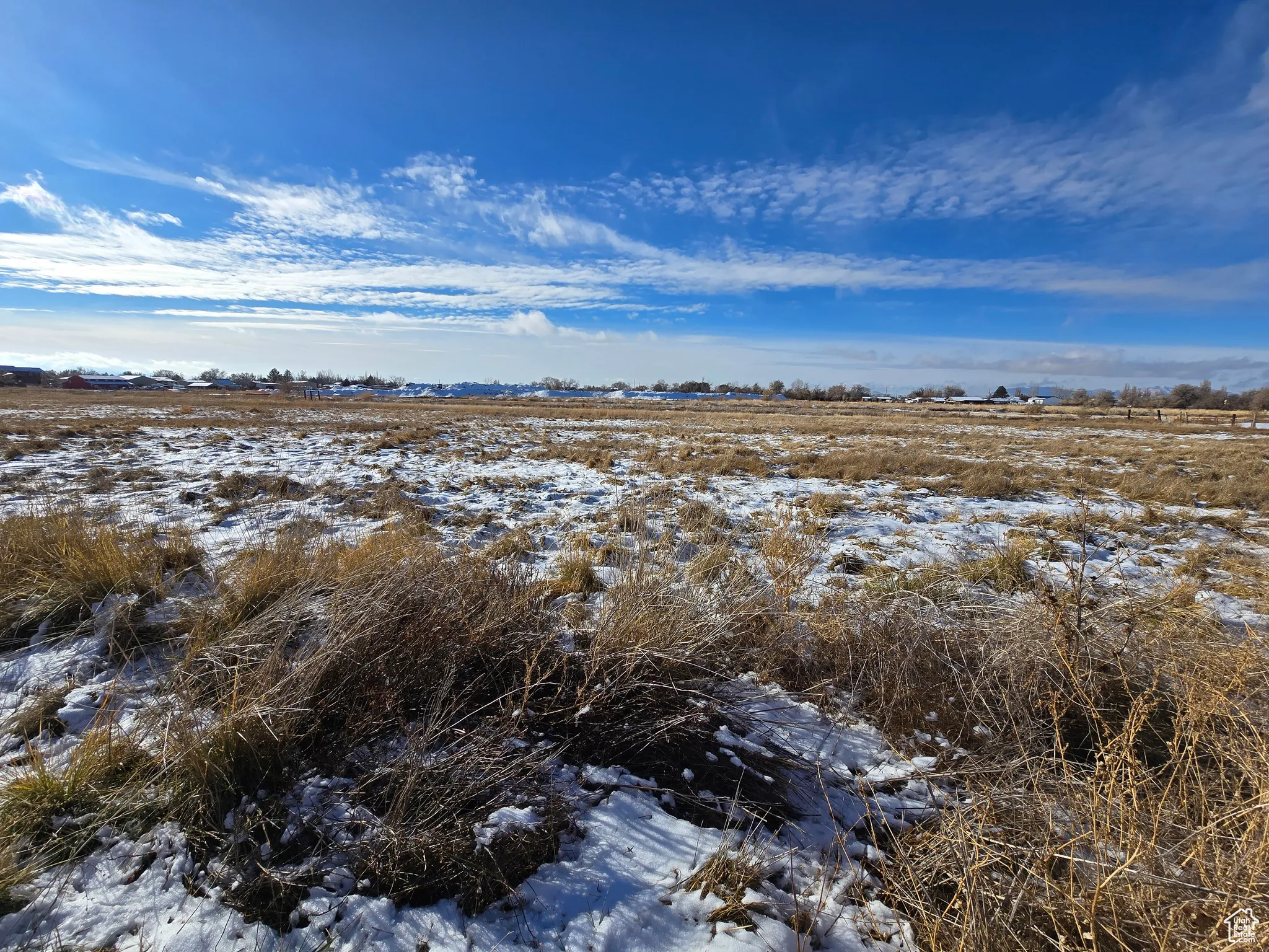 View of snow covered land featuring a rural view
