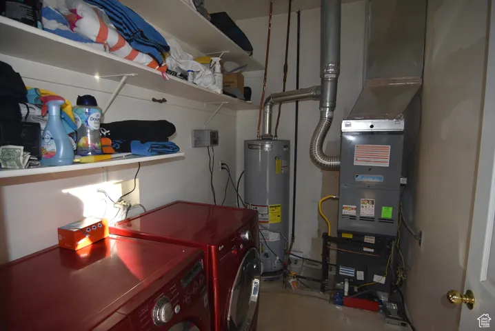 Laundry room with washer and dryer and water heater