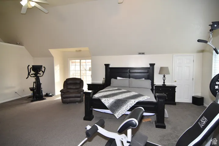 Bedroom with carpet flooring, ceiling fan, and lofted ceiling