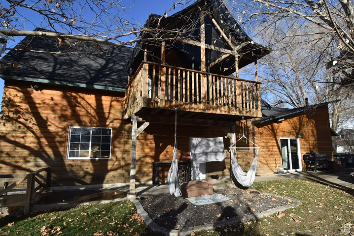 Rear view of house with a deck and a patio area
