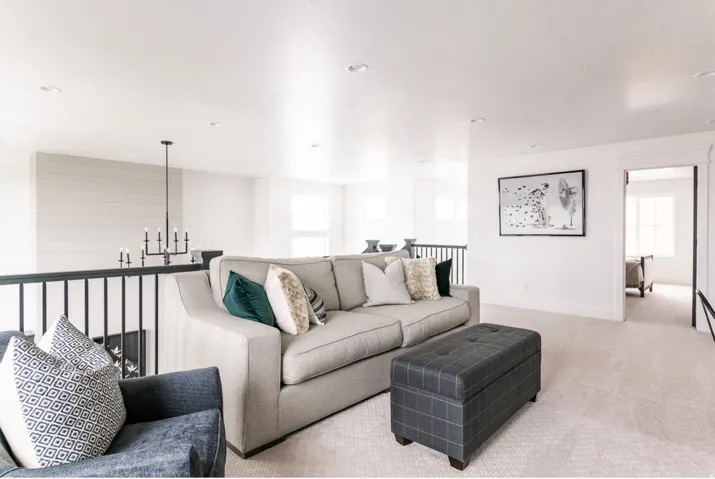 Upper-level landing featuring light-toned carpeting and recessed lighting