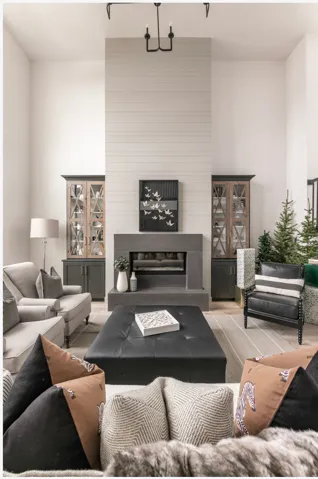 Living area featuring a floor-to-ceiling fireplace with a shiplap facade and a stone-finish hearth