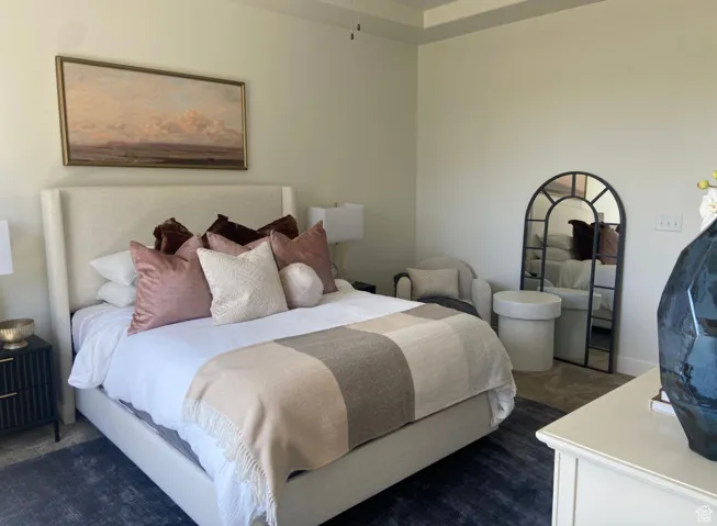 Bedroom with dark colored carpet