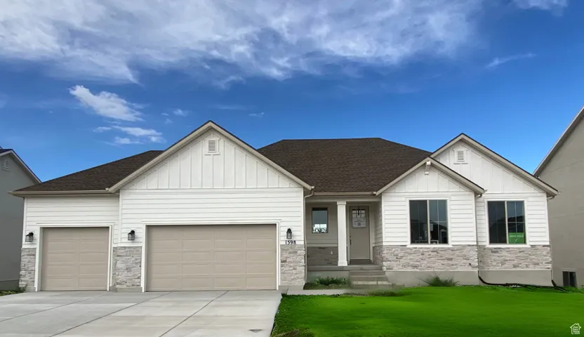 View of front of home featuring a garage and a front lawn