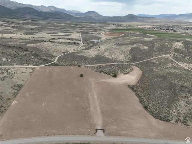Birds eye view of property with a rural view and a mountain view