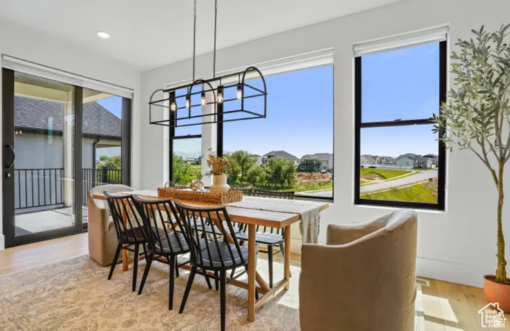 Dining area with a notable chandelier and light hardwood / wood-style floors