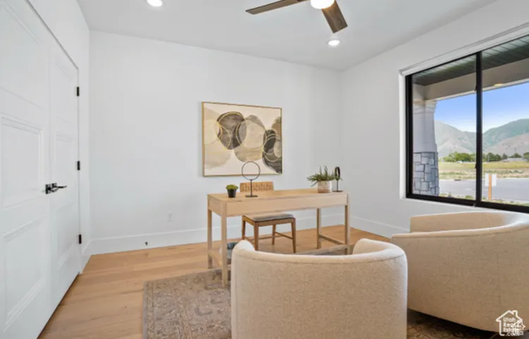 Office with ceiling fan, hardwood / wood-style flooring, and a mountain view