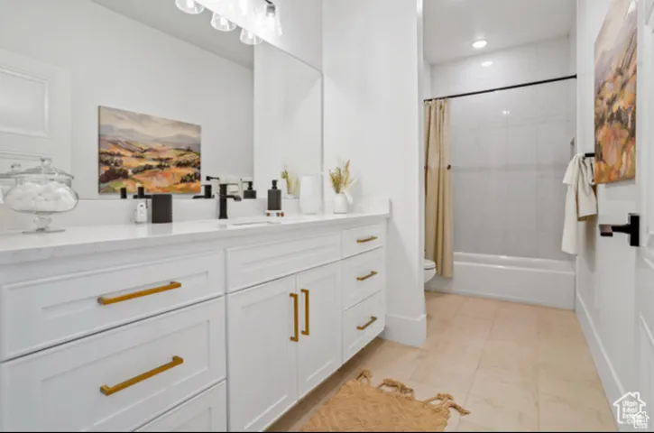 Bathroom featuring vanity and shower / bath combo