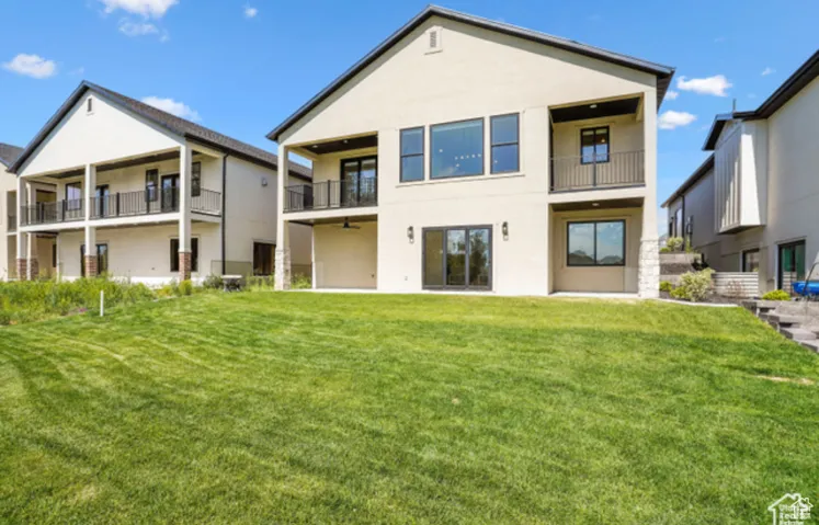 Rear view of house with a lawn