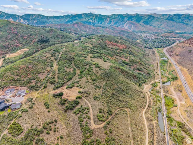 Aerial view of property and surrounding area with mountains