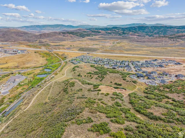 Aerial view of property and surrounding area with rural landscape and a water and mountain view