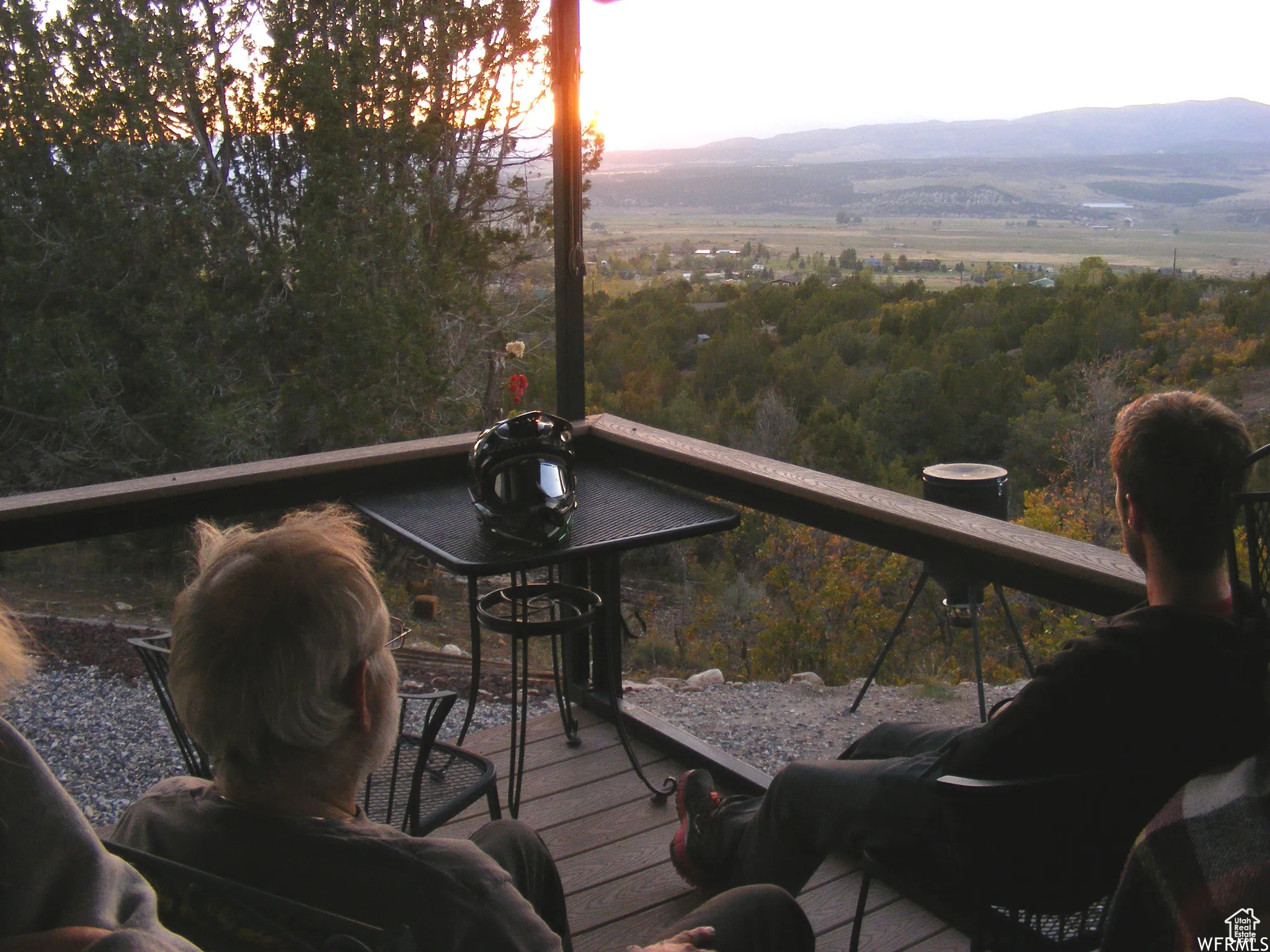 Deck at dusk featuring a mountain view