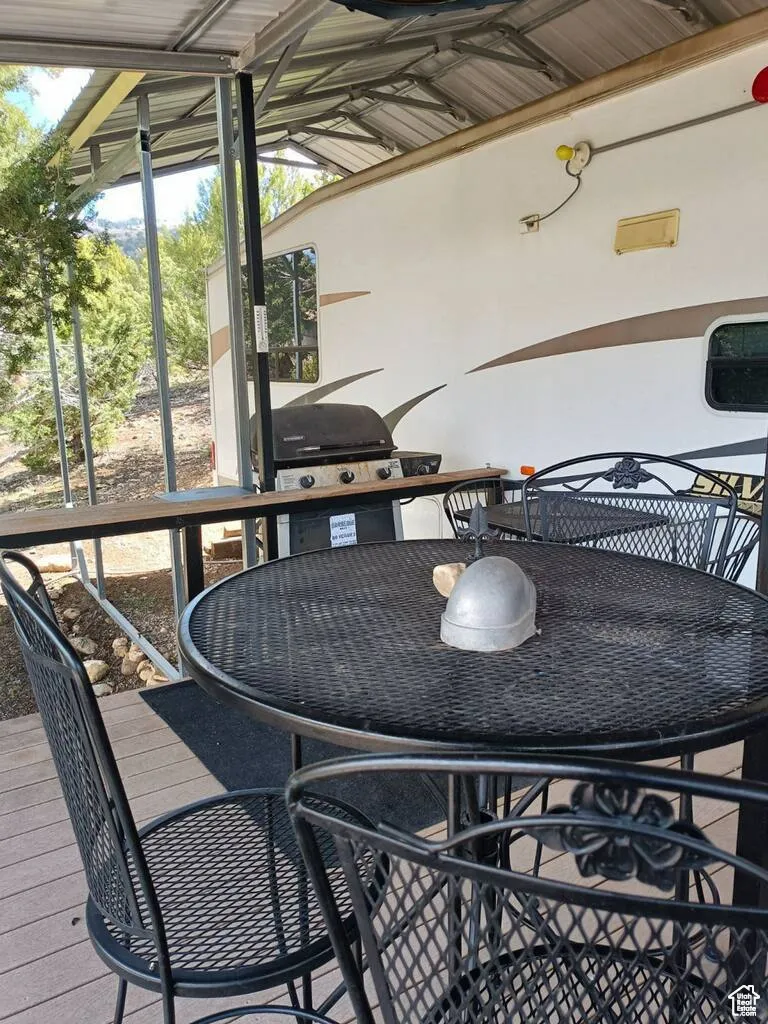 Wooden terrace featuring grilling area