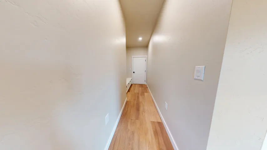 Corridor featuring baseboards and light wood finished floors