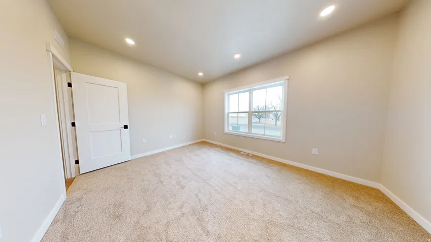Unfurnished room with recessed lighting and light carpet