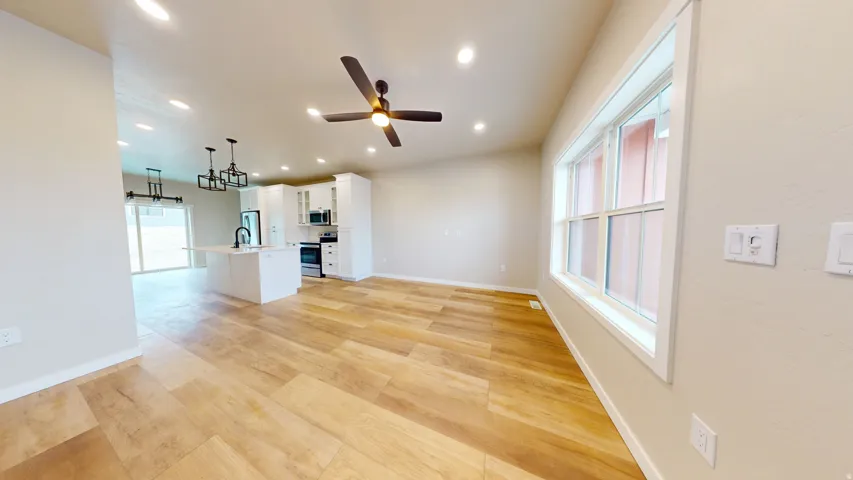 Unfurnished living room featuring light wood-style floors, recessed lighting, and a ceiling fan