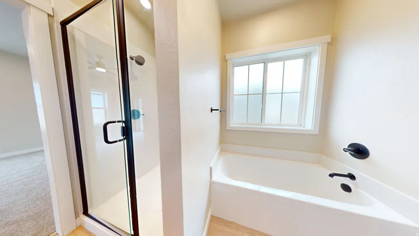 Bathroom with a stall shower and a bath