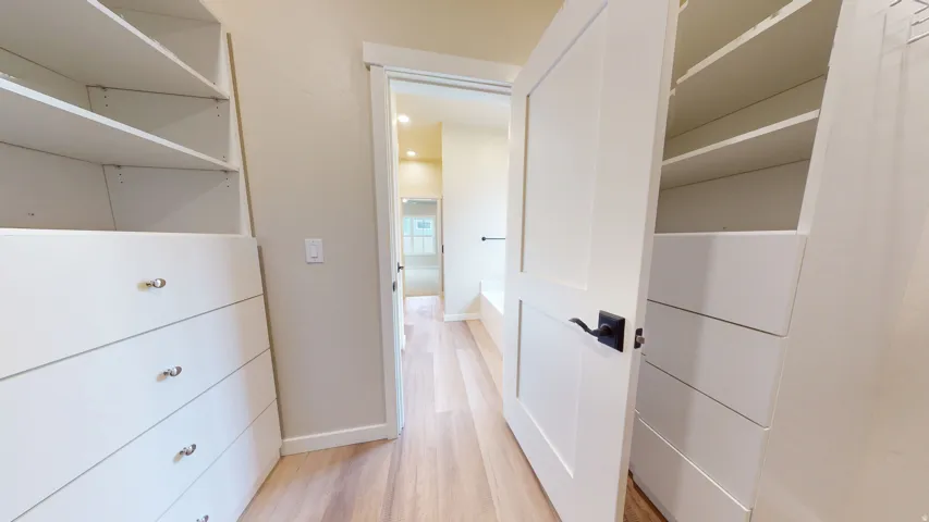 Walk in closet featuring light wood-type flooring