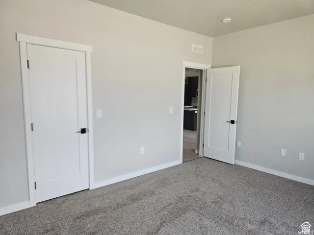 Empty room with carpet flooring