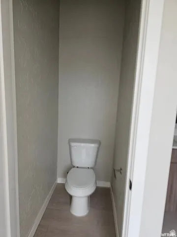 Bathroom featuring hardwood / wood-style flooring and toilet
