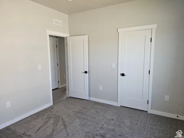 Unfurnished bedroom with carpet