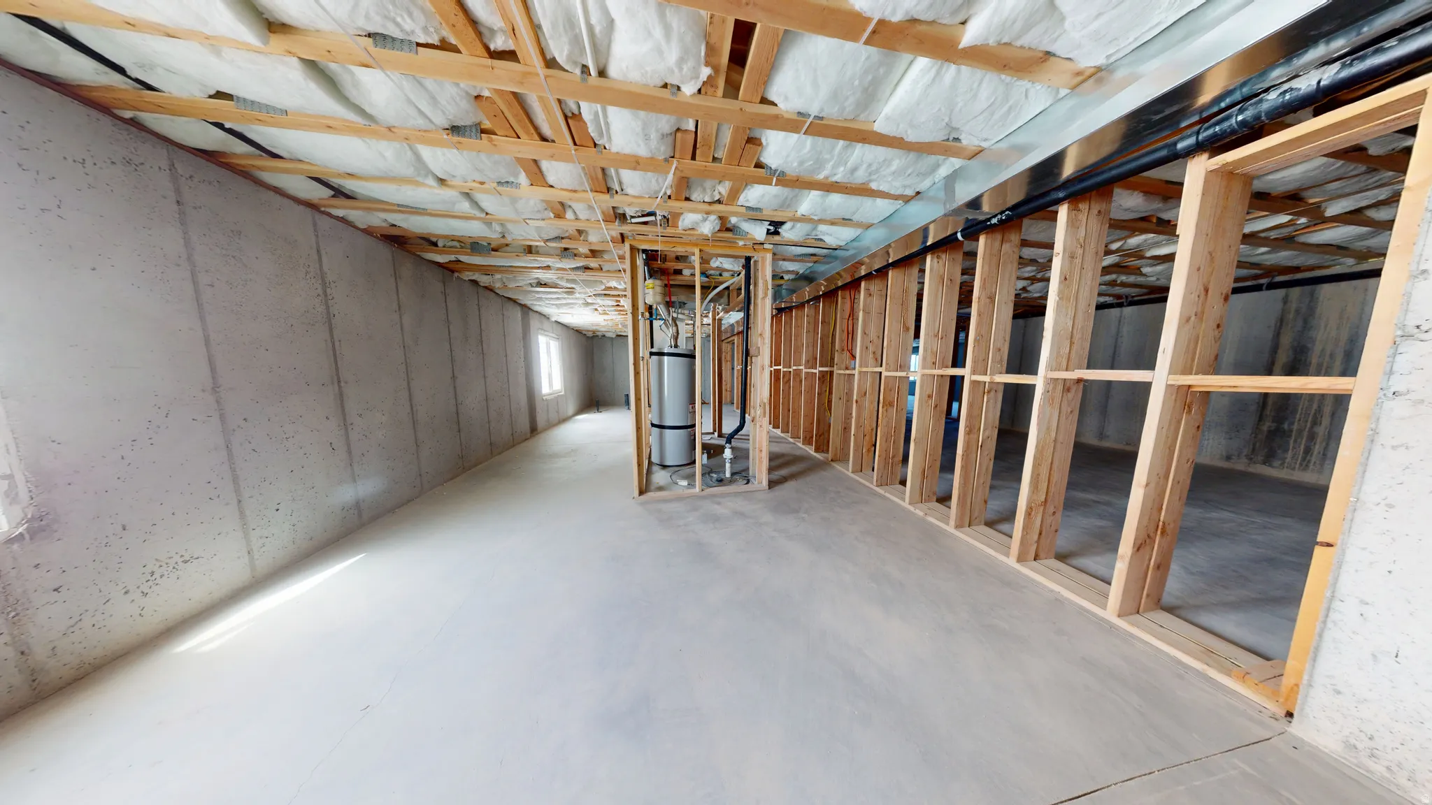 Unfinished below grade area featuring gas water heater