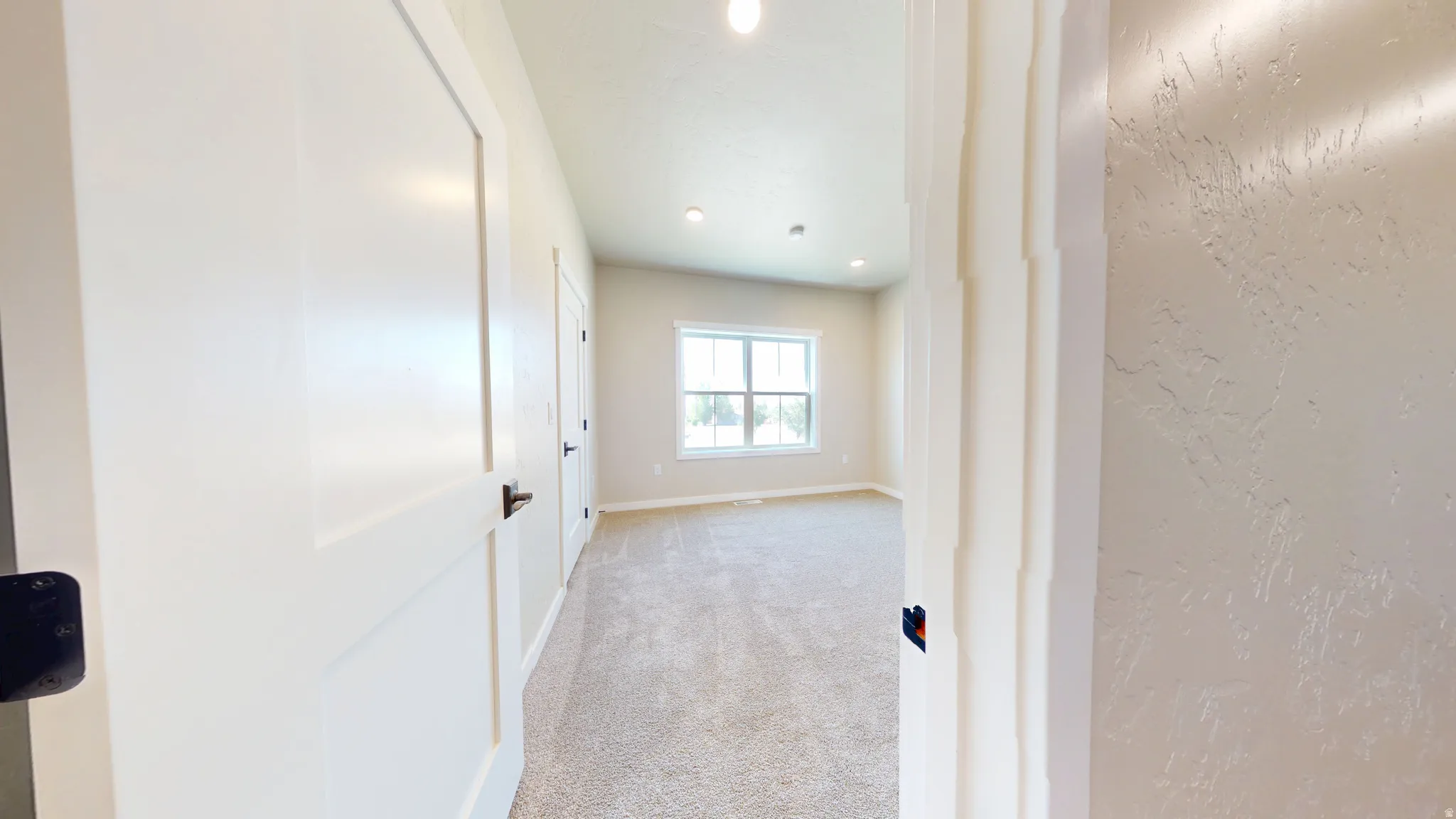 Hall featuring carpet flooring and recessed lighting