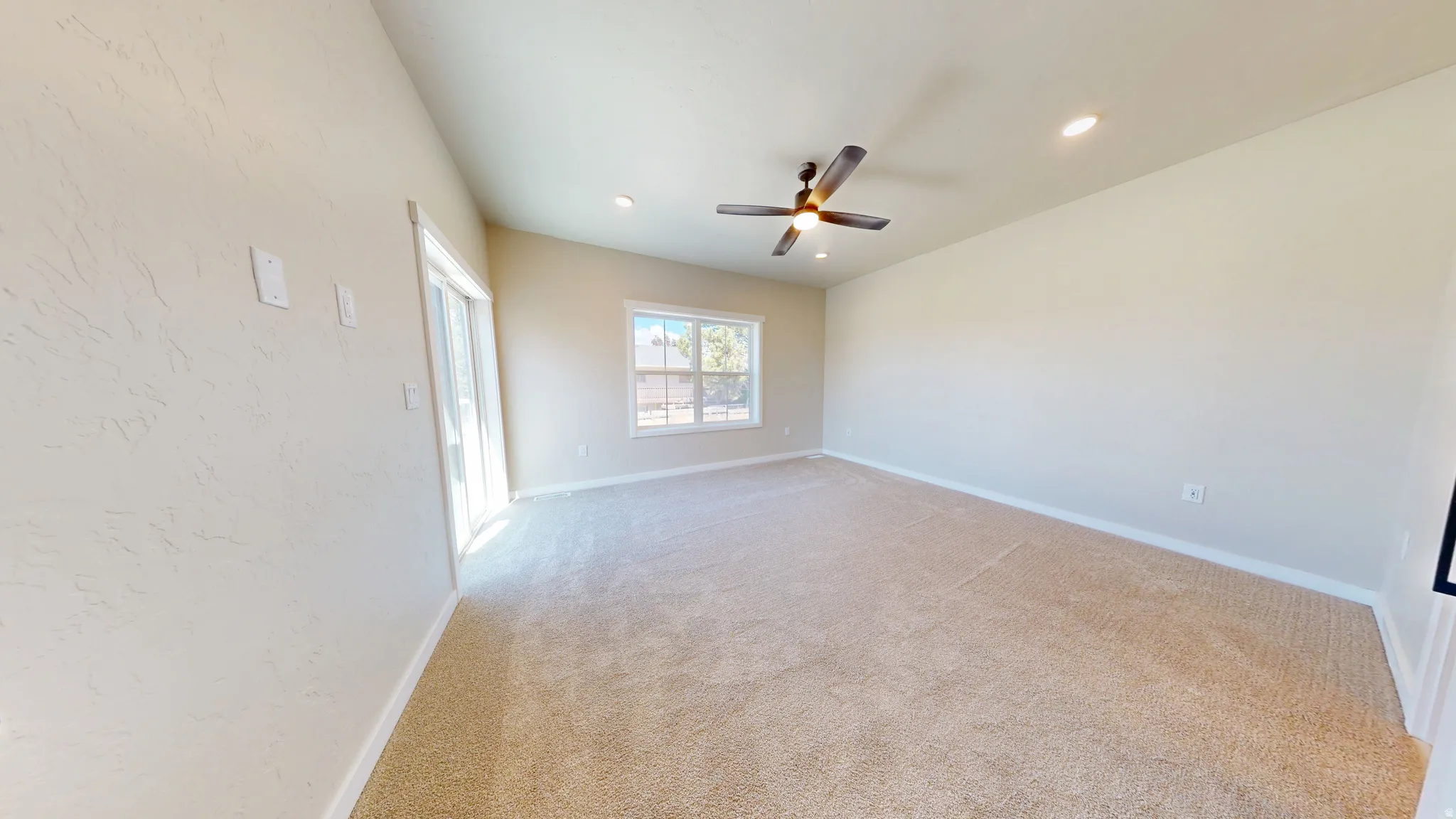 Empty room featuring light carpet, recessed lighting, and a ceiling fan