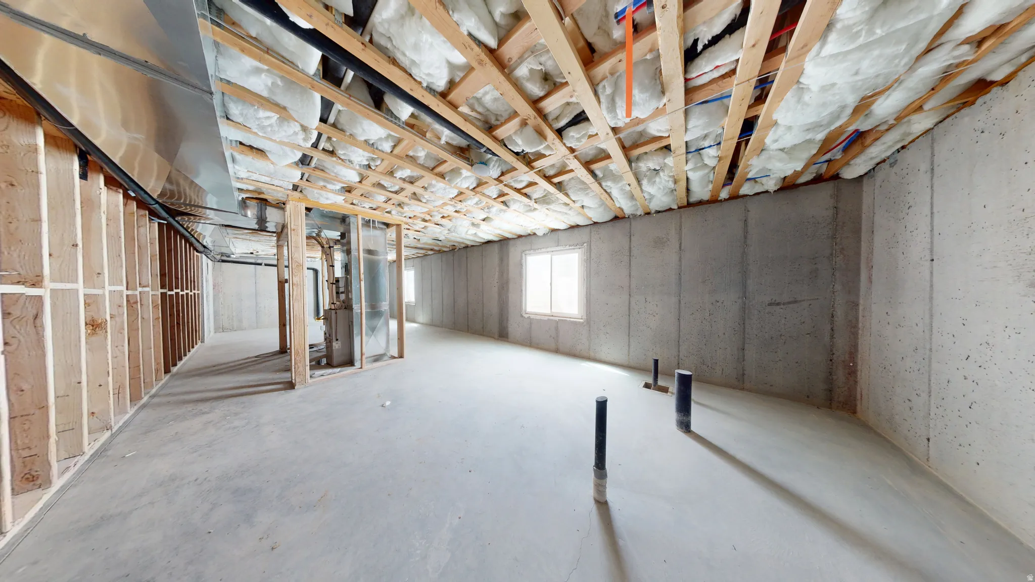 Basement featuring heating unit