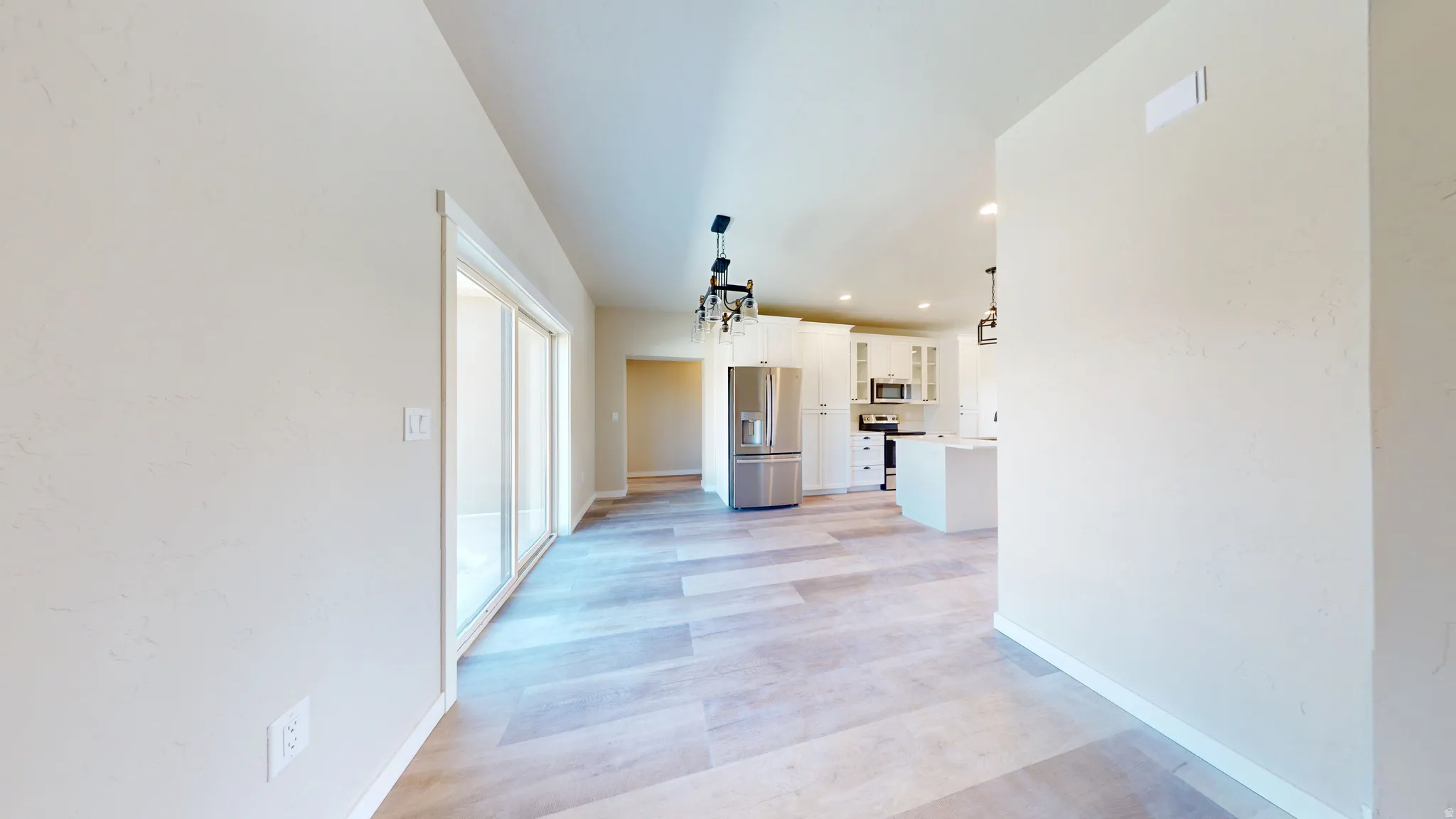 Hallway featuring recessed lighting and light wood-style floors