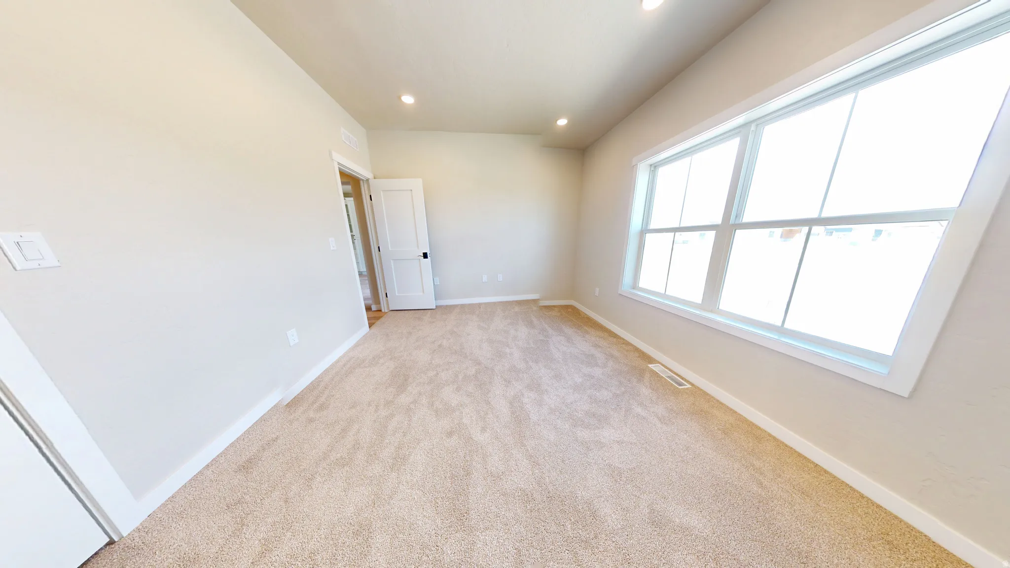 Unfurnished room featuring light colored carpet and recessed lighting