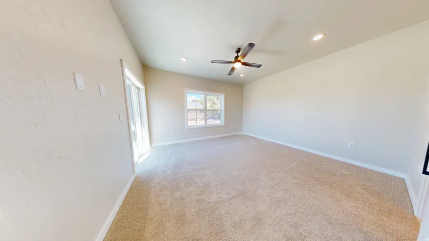 Empty room featuring light carpet, recessed lighting, and a ceiling fan