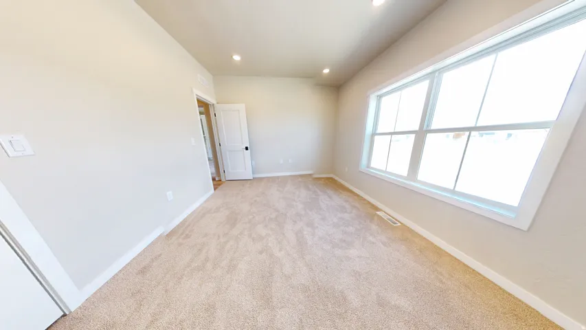 Unfurnished room featuring light colored carpet and recessed lighting