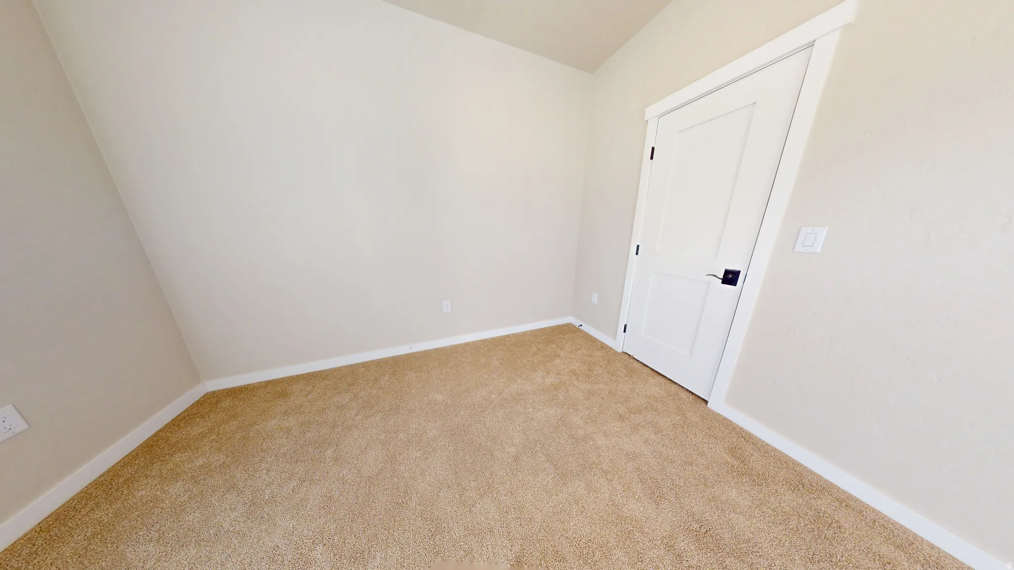 Empty room with carpet and baseboards