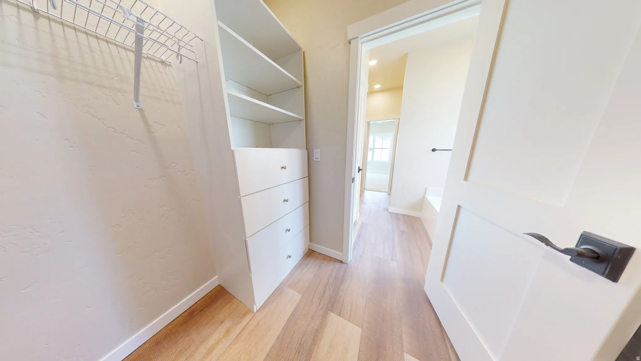 Walk in closet featuring light wood finished floors